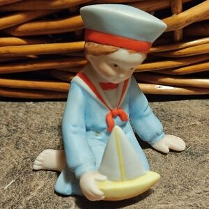 Holly Hobbie Enchanted Voyage porcelain figurine of a boy with a sailboat